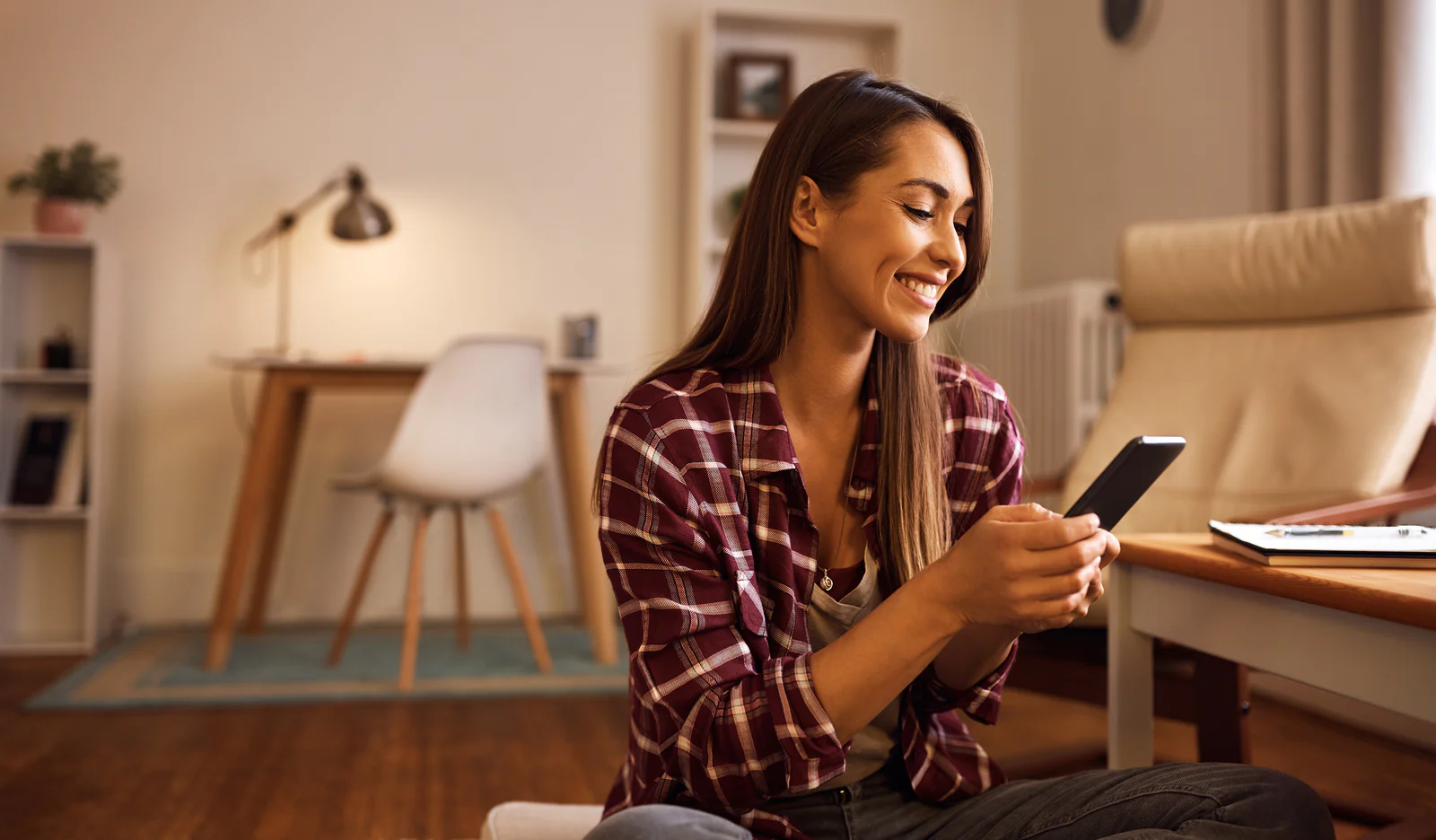 Woman smiling at her phone.