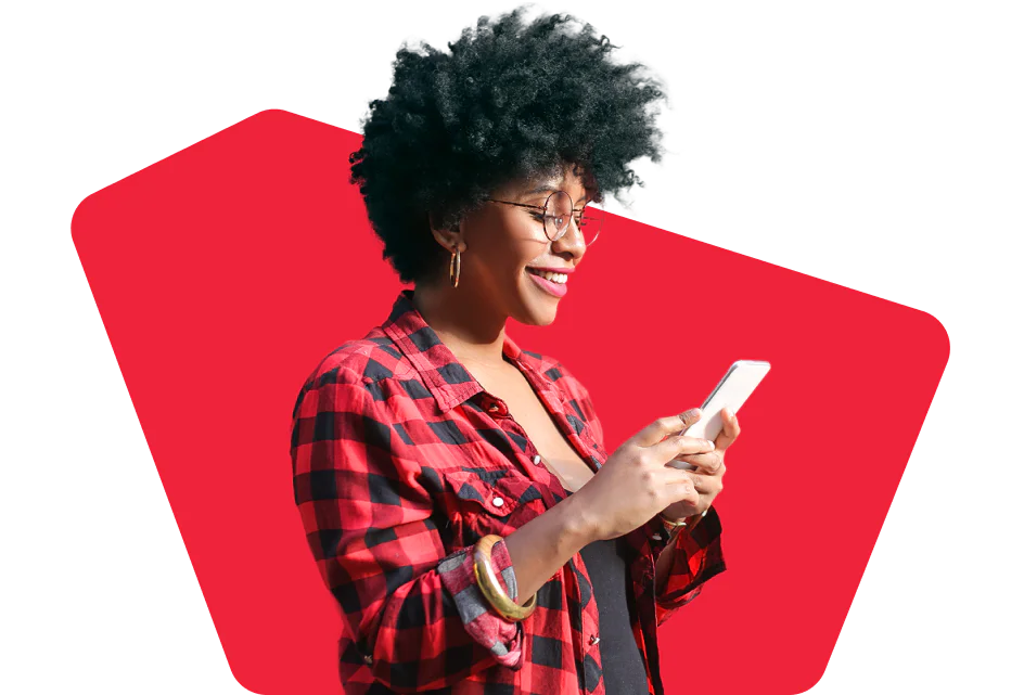 Woman in a red plaid shirt smiling and using a smartphone